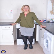 Naughty British housewife getting wet in her kitchen