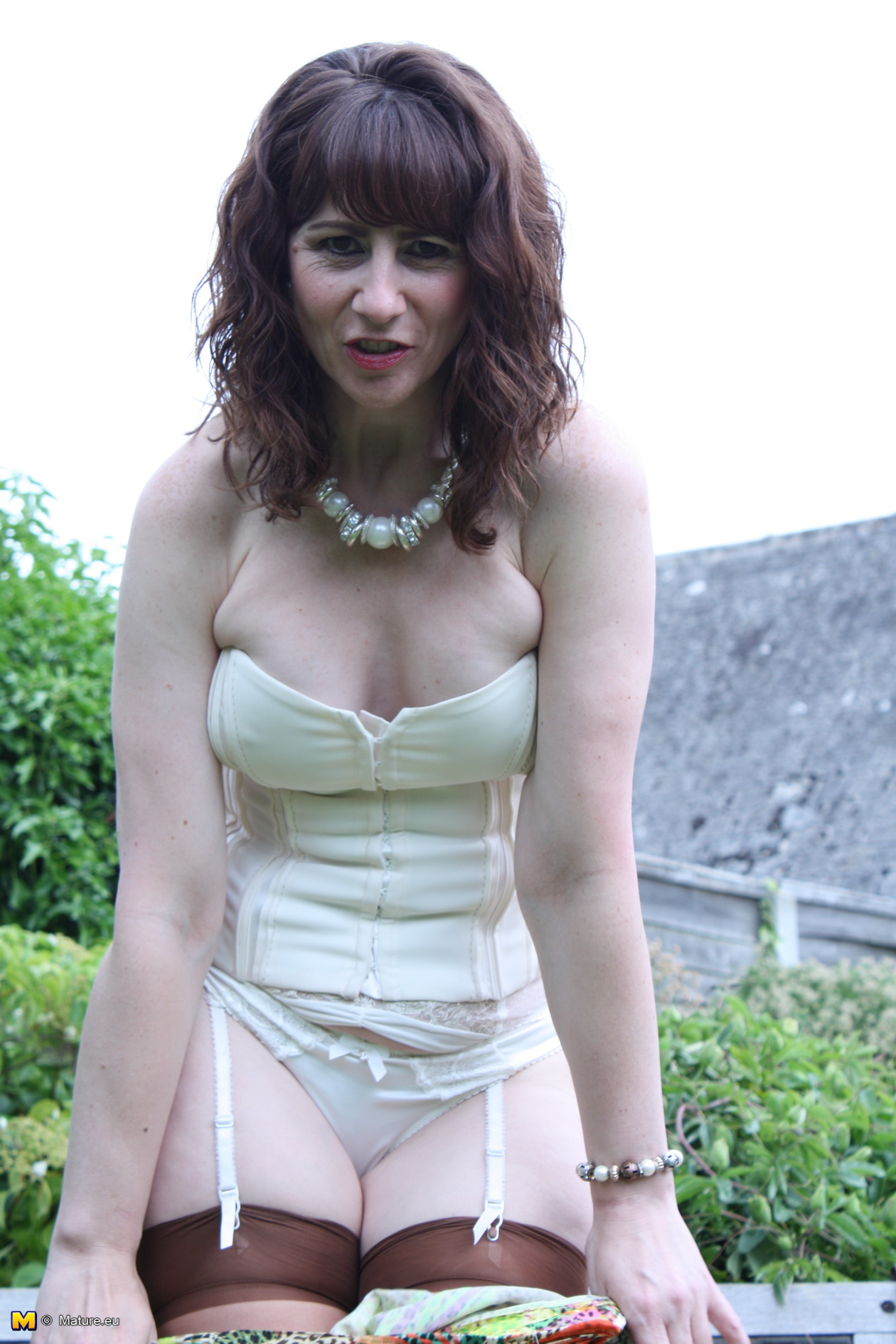Horny British housewife playing in the garden photo picture
